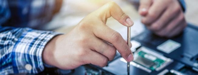 Close-up of human hand repairing computer