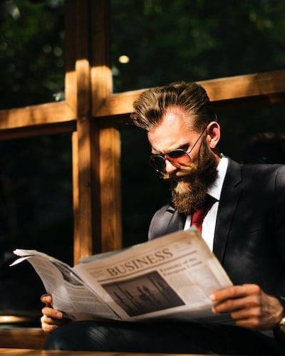 Image of a man reading a business newspaper